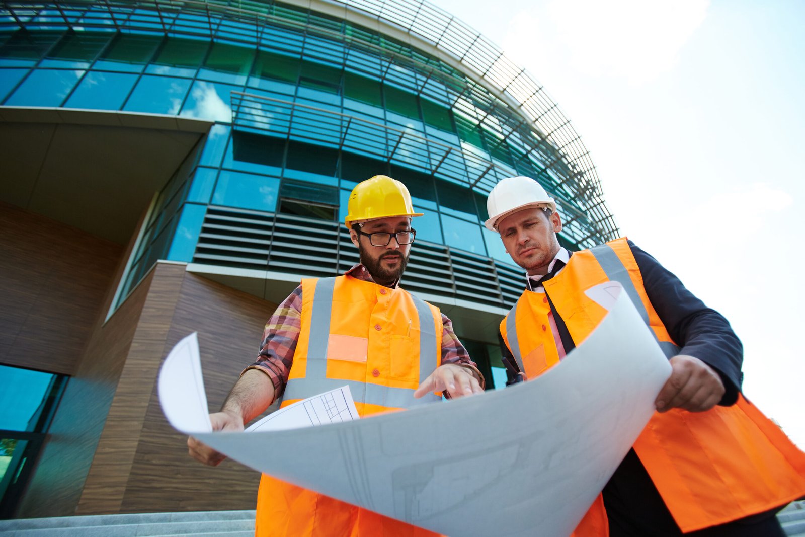 Builder explaining sketch on paper to his co-worker